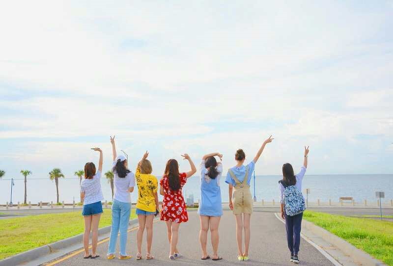 group of girls posing on the road in front of lake Pontchartrain