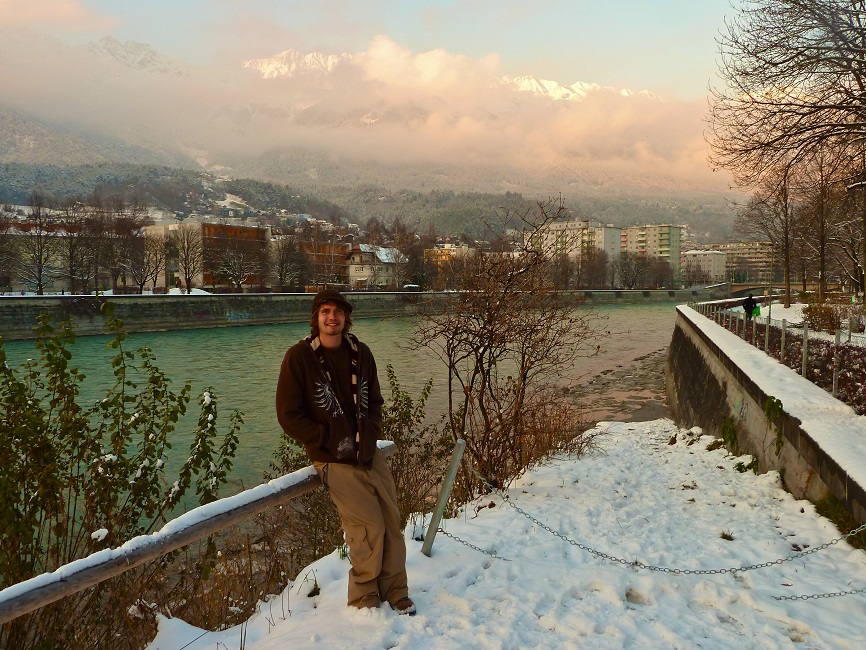 Student in posing in front of scenic austrian landscape