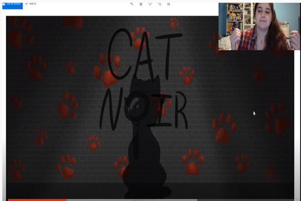 University of New Orleans student Victoria Preston explains her artist role in developing the “Cat Noir” murder mystery game.